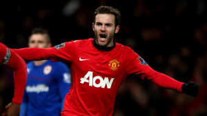 Juan Mata of Manchester United celebrates Robin van Persie scoring their first goal during the Barcl